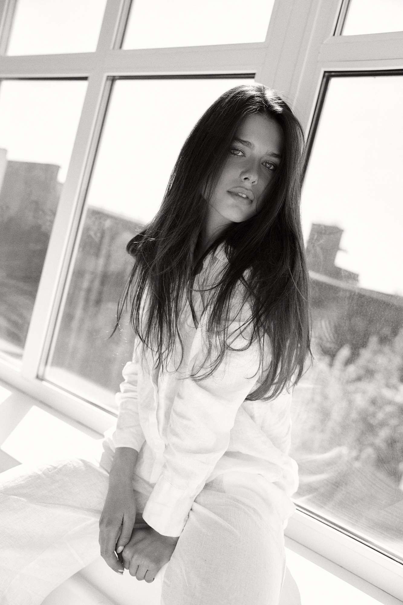Sofya Breydo in a white shirt, studio.
